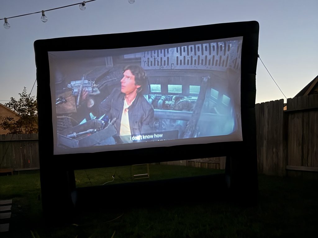 Watching Star Wars with kids on a projector outside