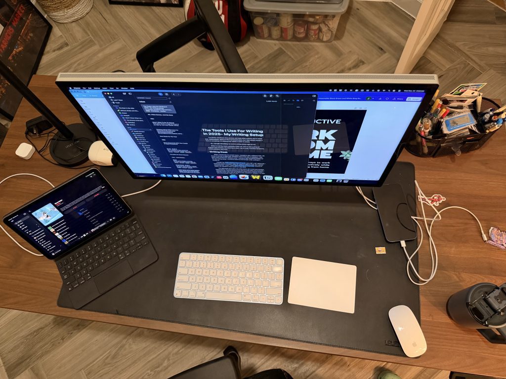 My writing setup with a Apple Studio Display, iPad, and keyboard on an Uplift V2 desk
