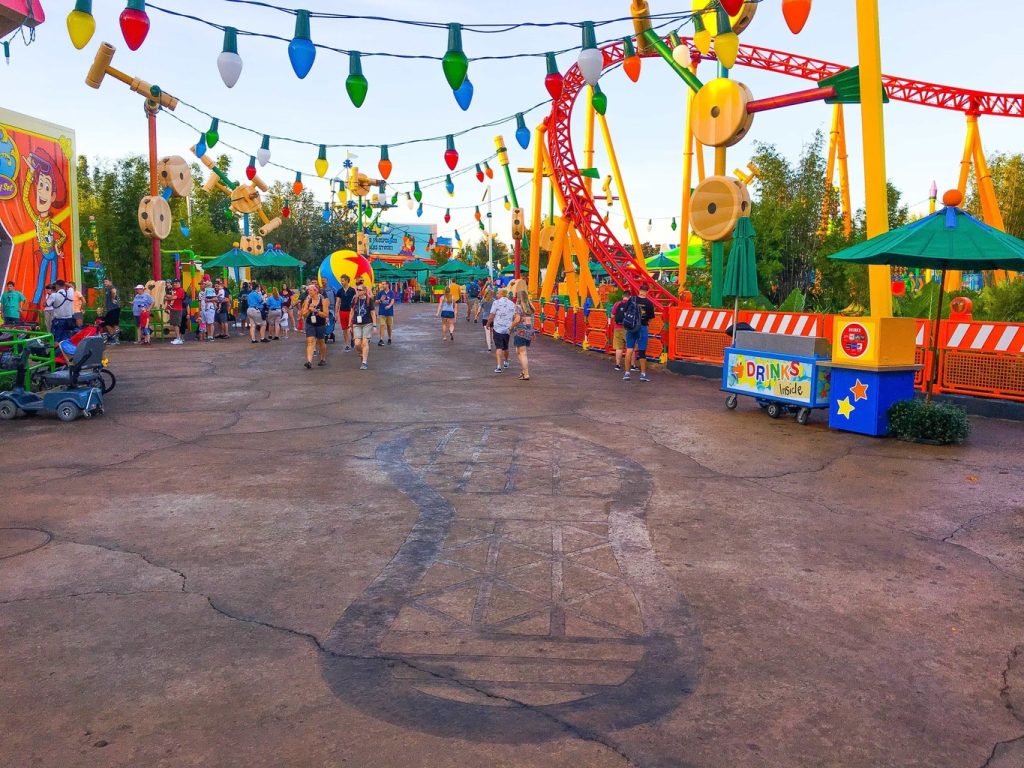 A photo of Andy's footprint on the ground at Toy Story World
Taken from https://collinsrace1.wordpress.com/2023/05/23/visiting-toy-story-land-at-disneys-hollywood-studios-2/andys-footprint-in-toy-story-land/