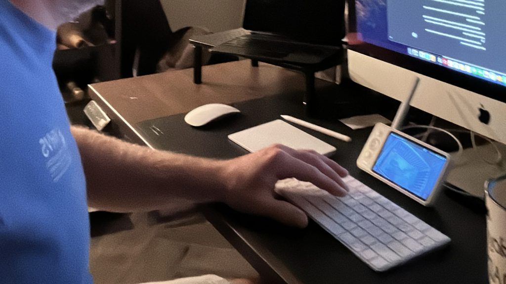 Writing In The Margins - How I Find Time for Writing As A Stay-at-Home Dad 2 A desk with a desktop, keyboard, and baby monitor. This was me, writing as a stay-at-home dad while the kids slept