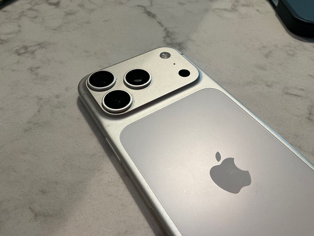 The iPhone 17 Pro One Year Later Review - An Amazing Device or No? 2 My silver iPhone 17 Pro One Year later, sitting on a white marbel table