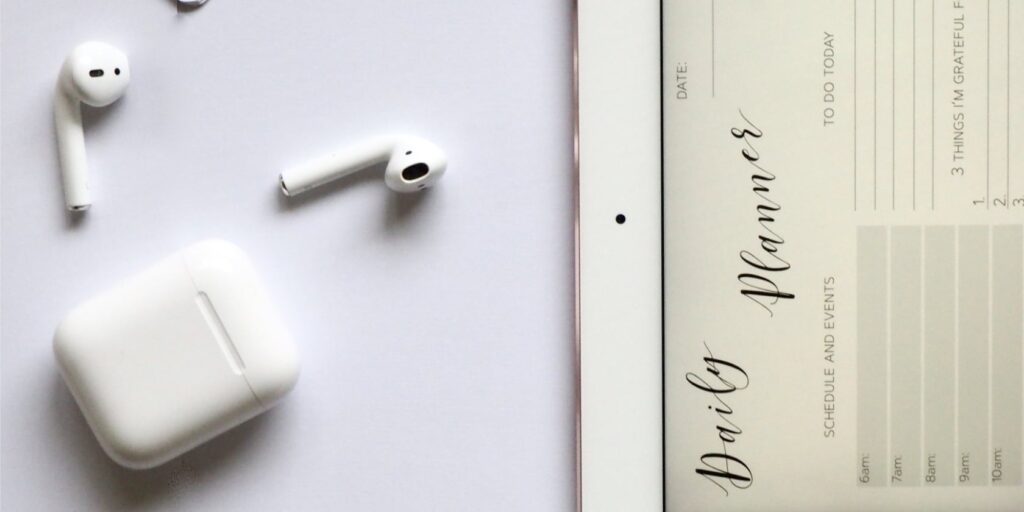New AirPod patent discovered for improved fit and biometrics 4 a pair of AirPod 2s on a desk with an iPad