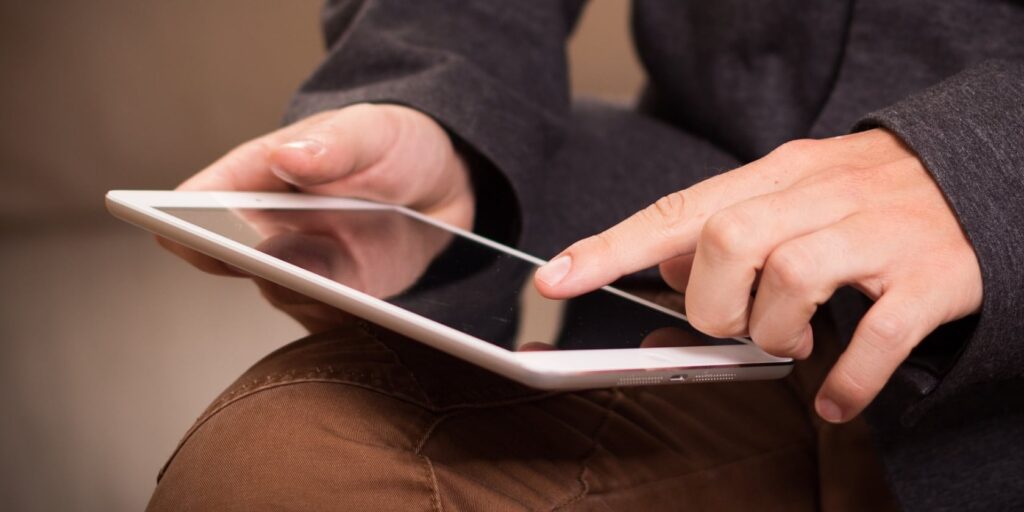 The Tablet War | Should Toddlers Have Tablets 3 using hands on an iPad to deal with text