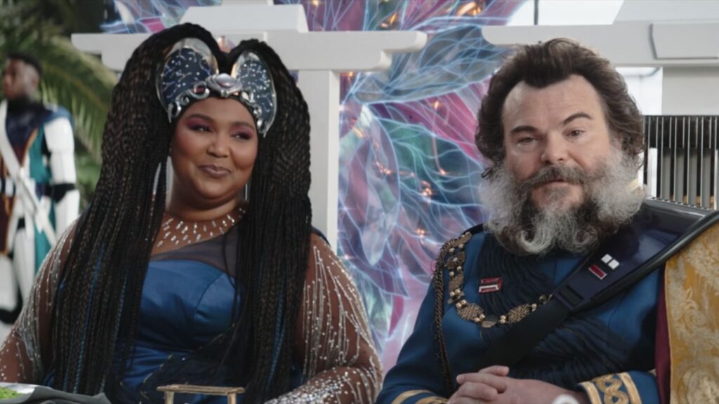 The Mandalorian Season 3 Episode 6 - A Boring Exploration into Droid Rights 3 Lizzo, in a blue and brown top, and silver crown, with translucent pink and blue wings, looks at Jack Black, dressed in the same colors in the last est episode of The Mandalorian, Season 3, episode 6