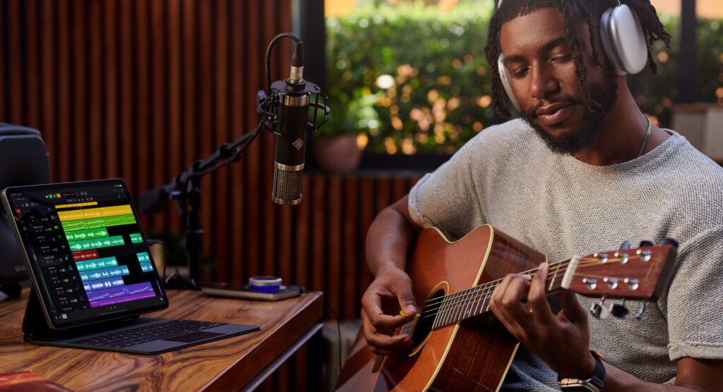 With Final Cut Pro and Logic Pro for the iPad, Apple Shows It's Not Done With The Tablet 4 Someone recording guitar on Logic Pro for iPad