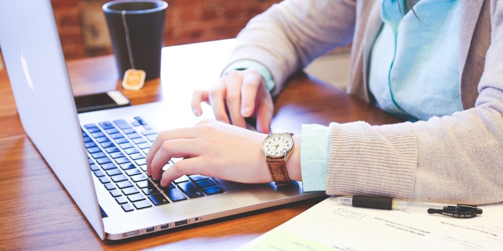 A Great Way To Help Your Indie Author Friends 5 an Indie Author typing on a laptop