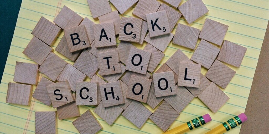 Back To School For Teachers - Why They Need More Time To Themselves 2 Tiles on a notepad that spell out Back To School