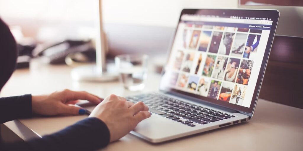 someone using a laptop to tag people's faces in Apple's Photos