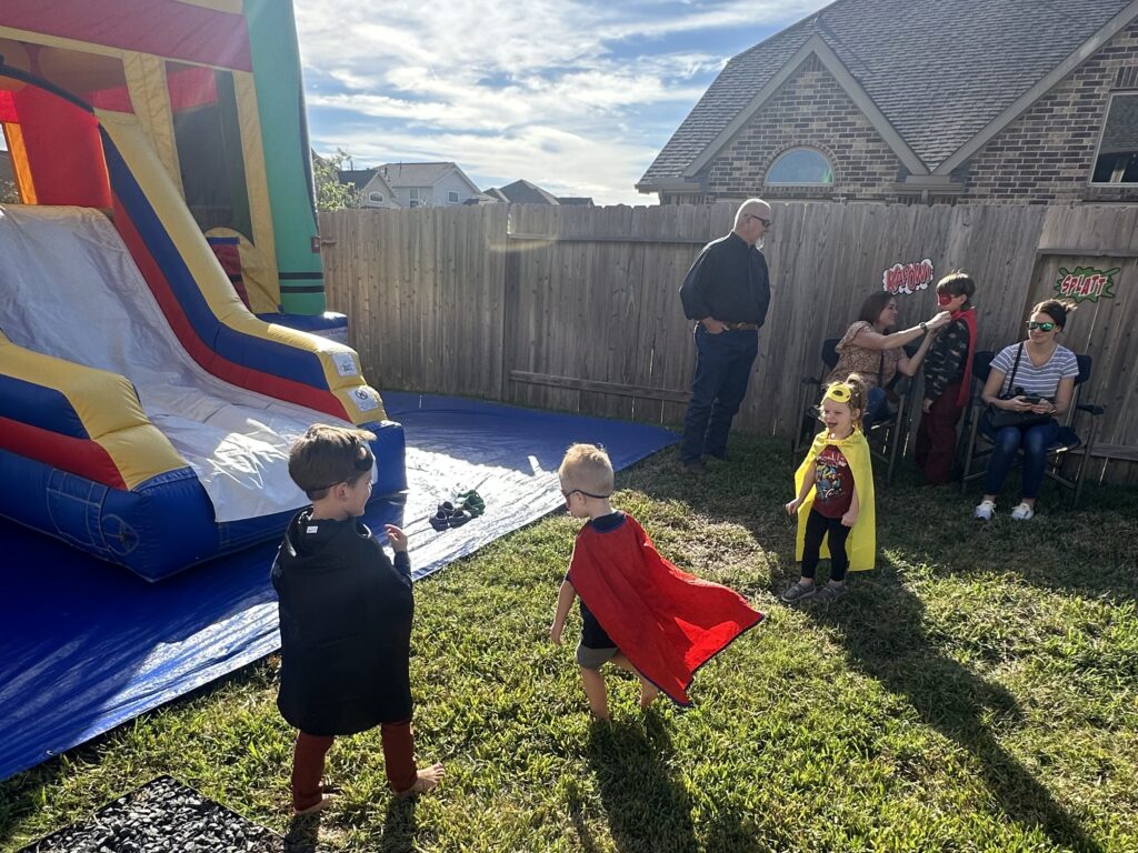 Pink Eye, Road Trips, Birthdays, and Thanks! 7 Thing young kids with capes and a bounce house