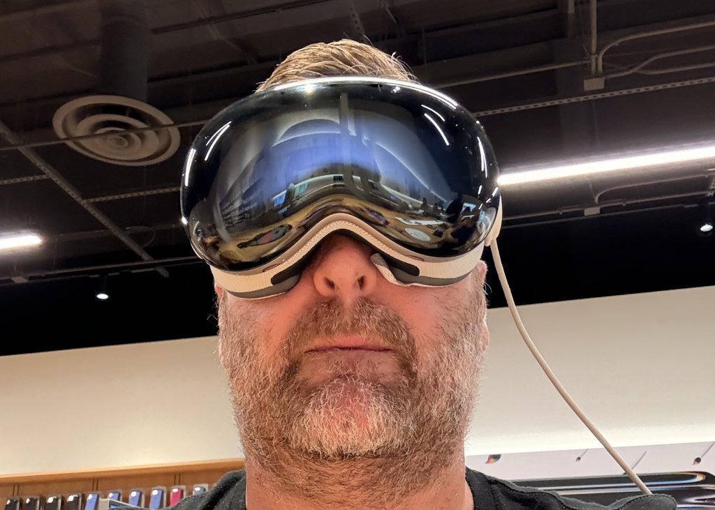 Trying the Apple Vision Pro Again: A Year Later, Here’s What Changed 3 Close-up of a person wearing the Apple Vision Pro headset inside an Apple Store during a demo