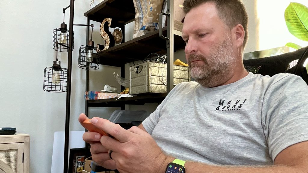 First iPhone 17 Pro Impressions—A Writer’s Perspective 4 A man typing on an iPhone 17 Pro in landscape orientation