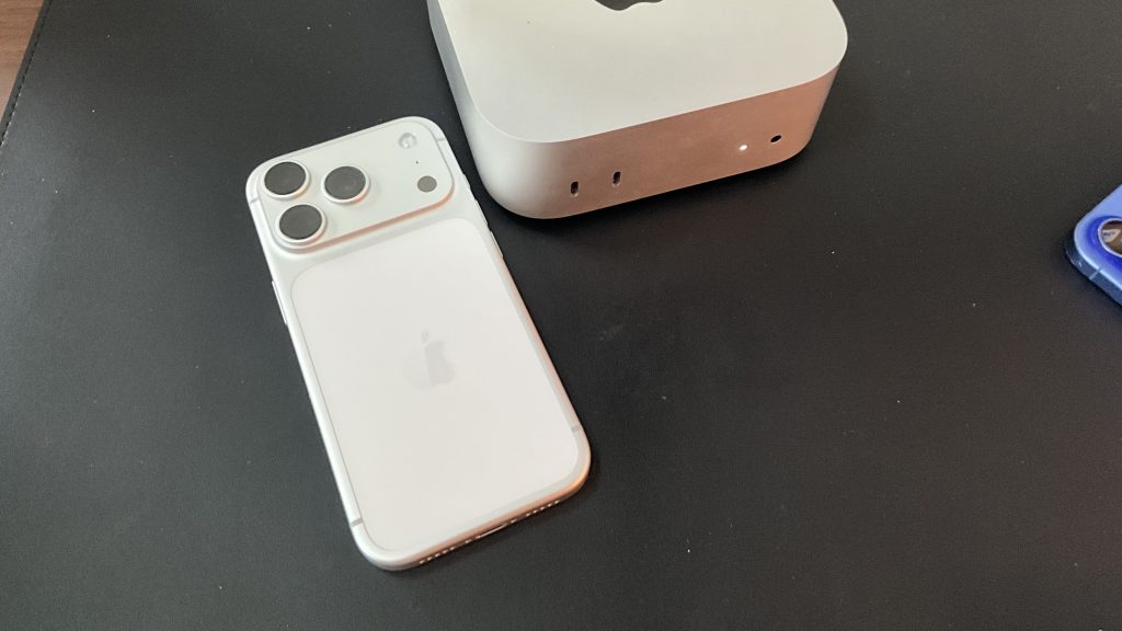 First iPhone 17 Pro Impressions—A Writer’s Perspective 5 a silver iPhone 17 Pro face down on a desk next to a Mac Mini for my iPhone 17 Pro impressions article