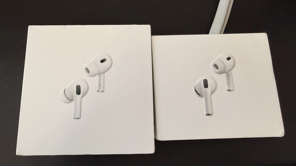 AirPods Pro 3 Review: Real-Life Impressions Of Fit, Sound Quality, Health Features, And More 3 The AirPods Pro 2 box next to the AirPods Pro 3 box on a black desk.