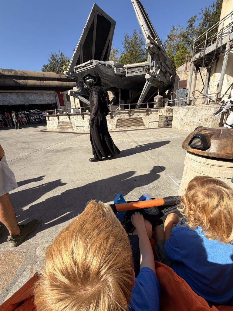 Conquering Disney World— My First Visit in Almost 40 Years 14 Kylo Ren walking in front of a stroller with two children in it