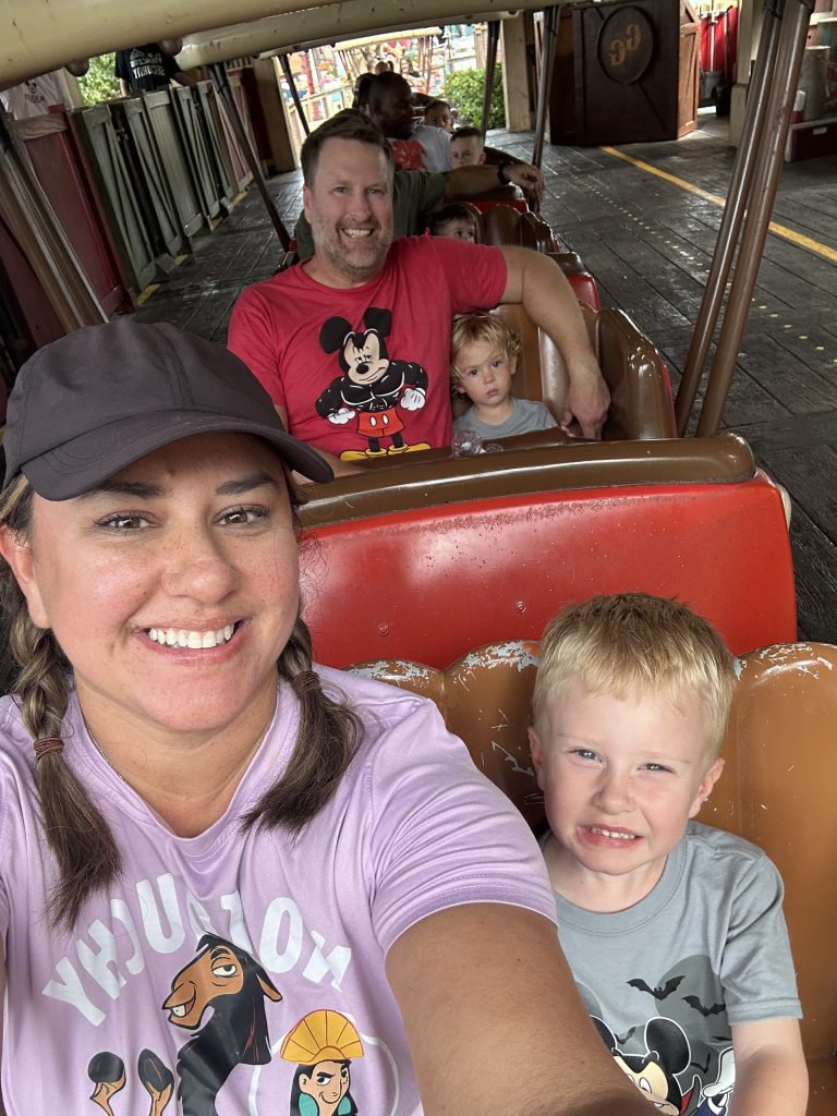Conquering Disney World— My First Visit in Almost 40 Years 26 A family sitting one adult and one kid to a row on a roller coaster