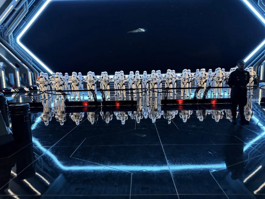 Stormtroopers in formation on a spaceship deck, facing a dark starry sky.