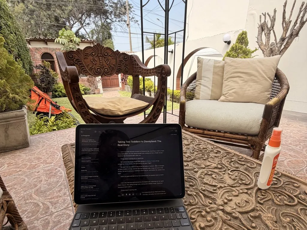 iPad Productivity Put to the Test: I Wrote a Blog Post from Peru 2 working on my iPad productivity on patterned table with wicker chairs, garden view, and sunscreen bottle.