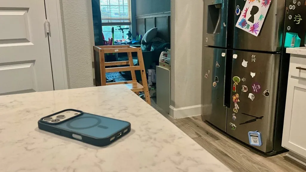 Leaving an iPhone behind on the kitchen counter to avoid distractions during family time.