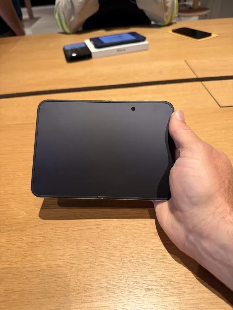 First iPhone Duo Impressions: Pick Up and Setup 3 a hand holding an iPhone Duo with the screen off, getting iPhone Duo first impressions